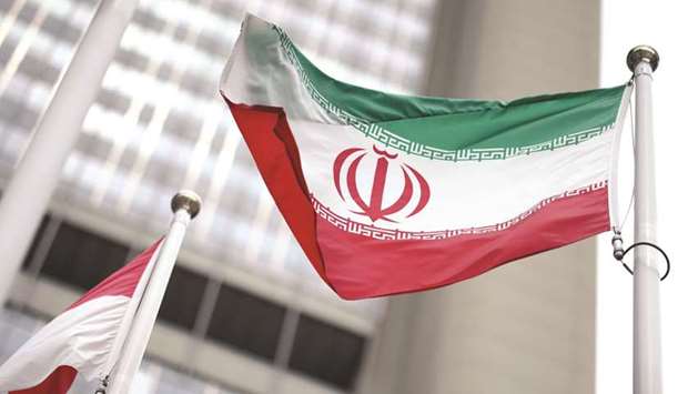 Iranian flag flies in front of the UN office building, housing IAEA headquarters, in Vienna, Austria on May 24. Iranu2019s national oil company has laid out plans to revive oil production in the event that US sanctions are removed, starting with an output hike to 3.3mn barrels a day within one month of the penalties being lifted, the official Shana news agency reported.