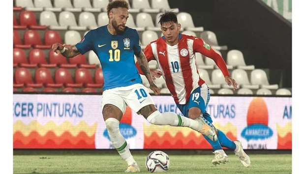 Brazilu2019s Neymar (left) and Paraguayu2019s Santiago Arzamendia vie for the ball during the South American qualification match for the FIFA World Cup Qatar 2022 in Asuncion, Paraguay, on Tuesday (AFP)