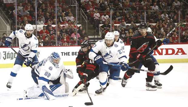 Carolina Hurricanesu2019 Jordan Martinook attempts a shot against Andrei Vasilevskiy (second from left) of the Tampa Bay Lightning during the third period in Game Five of the Second Round of the 2021 Stanley Cup Playoffs in Raleigh, North Carolina. (Getty Images/AFP)