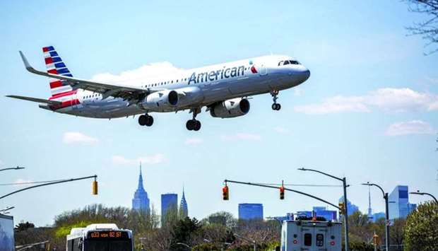 An American Airlines Group plane prepares for landing at LaGuardia Airport in New York. Looser restrictions have made domestic air travel an almost-routine experience in the US, save for the facemasks, with capacity for flights within the country at about 84% of 2019 levels, based on data from flight-tracking firm OAG.