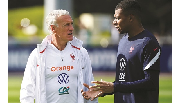 Franceu2019s head coach Didier Deschamps (left) chats with forward Kylian Mbappe during a training session in Clairefontaine-en-Yvelines, France. (AFP)