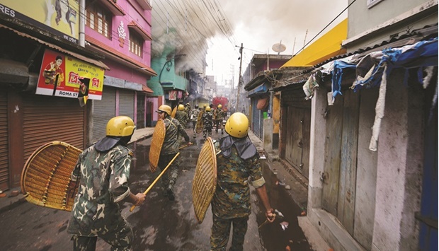 Security personnel patrols on a street after violence erupted between police and protesters in Howrah on the outskirts of Kolkata.
