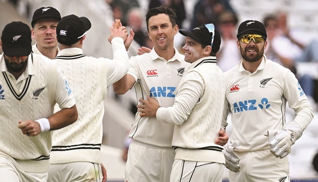 New Zealandu2019s Trent Boult (centre) celebrates taking the wicket of Englandu2019s Joe Root for 176 runs on day 4 of the second Test at Trent Bridge in Nottingham yesterday. (AFP)