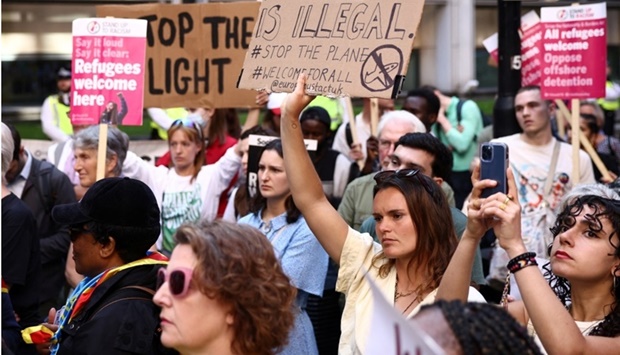 Protestors demonstrate outside the Home Office against the British Governments plans to deport asylum seekers to Rwanda, in London, Britain on June 13. REUTERS