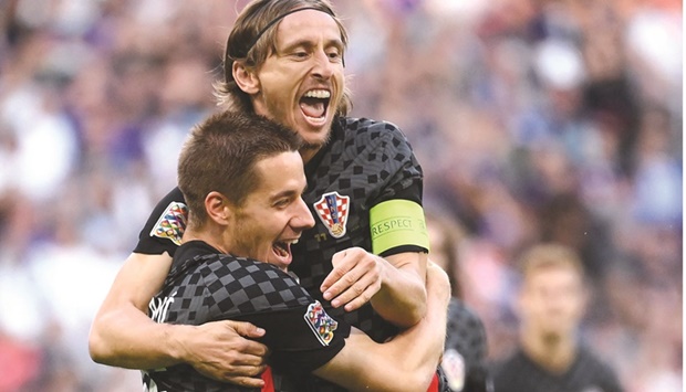 Croatiau2019s midfielder Luka Modric (right) celebrates his teamu2019s first goal with teammates during the UEFA Nations League match against France in Paris. (AFP)