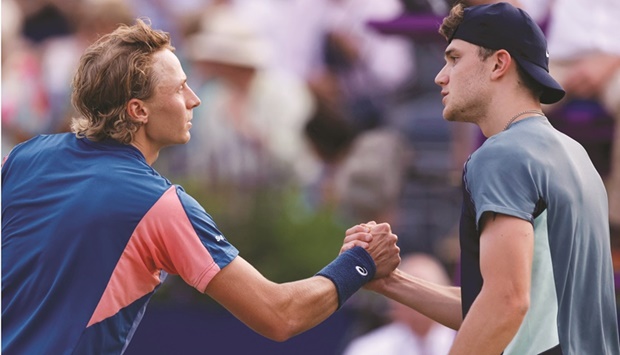 Finlandu2019s Emil Ruusuvuori shakes hands with Britainu2019s Jack Draper after winning their second round match at the ATP 500 Queenu2019s Club Championships in London yesterday. Ruusuvuori won 6-2, 7-6. (Reuters)