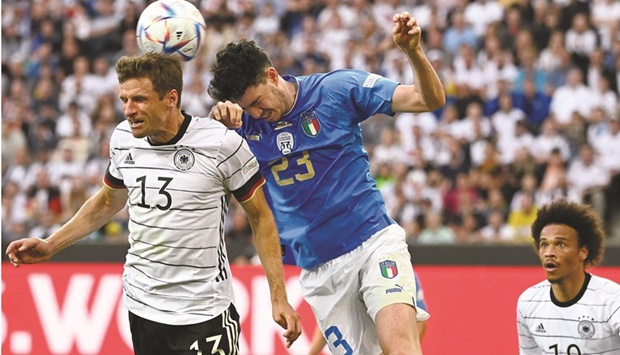 Germanyu2019s forward Thomas Mueller (left) and Italyu2019s defender Alessandro Bastoni vie for a header during the Nations League match in Moenchengladbach, western Germany, Tuesday. (AFP)