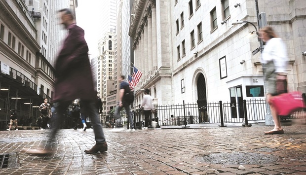 People walk by the New York Stock Exchange. Whipsawing bond yields, surging oil prices and a Federal Reserve bent on squashing the worst inflation in four decades are hampering investorsu2019 ability to assess US stock valuations, even as the marketu2019s tumble creates potential bargains.