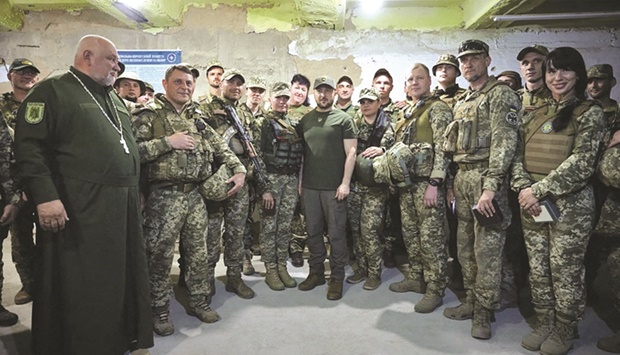 Ukrainian President Volodymyr Zelensky (centre) with servicemen during his visit to the position of troops in Mykolaiv region. (AFP)