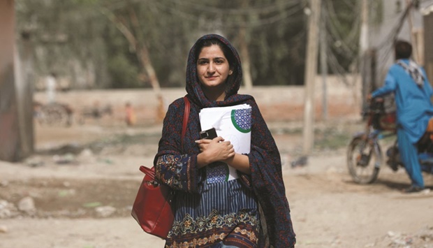 Liza Khan, 22, project manager at the Community Development Foundation, walks to her office in Jacobabad, Pakistan, last month. (Reuters)