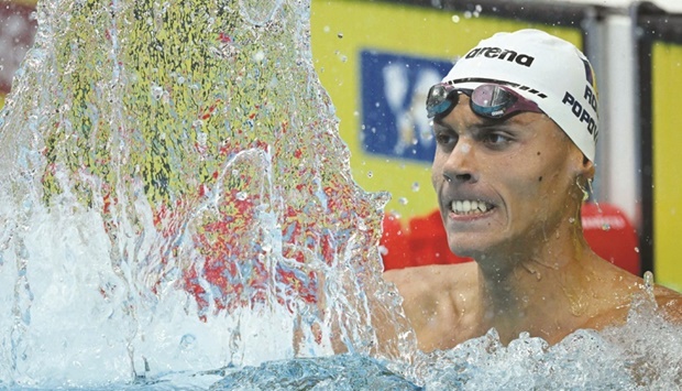 Romaniau2019s David Popovici reacts after winning the 200m freestyle at the World Aquatics Championships in Budapest. (AFP)