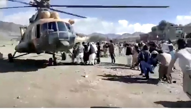 People carry injured to a helicopter following a massive earthquake, in Paktika Province, Afghanistan, June 22, 2022, in this screen grab taken from a video. Bakhtar News Agency/Handout via REUTERS