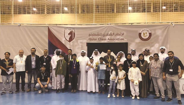 Winners of the Al Raheeb Open Chess Championship pose for a picture with officials.