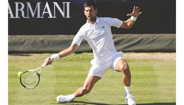 Serbiau2019s Novak Djokovic returns the ball to Felix Auger-Aliassime of Canada during their exhibition match at the Giorgio Armani Tennis Classic tournament at the Hurlingham Club in London yesterday. (AFP)