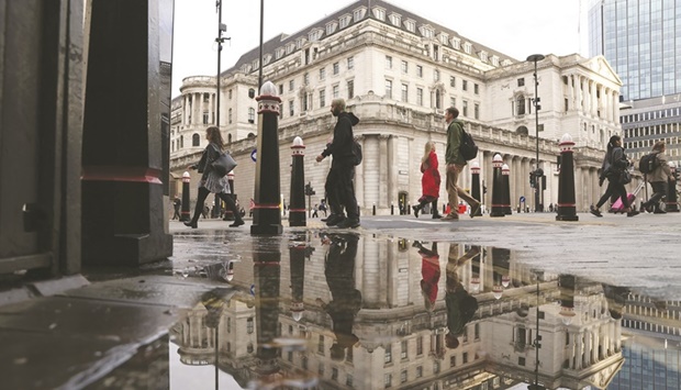 Pedestrians pass the Bank of England in the City of London. The BoE will soon stop paying interest on commercial bank deposits in a move that could save the UK taxpayer billions of pounds but hammer profits among high street lenders, according to a leading analyst.