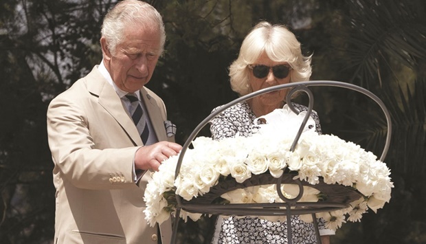 Prince Charles and his spouse Camilla pause in front of a flower wreath at the Kigali Genocide Memorial yesterday.