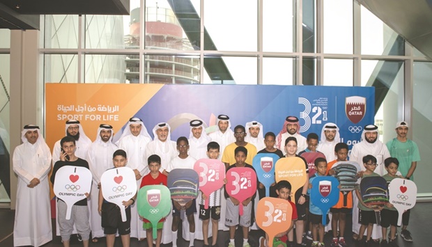 Qatar Olympic Committee secretary-general HE Jassim Rashid al-Buenain and other officials pose with children during the Olympic Day celebration at the 3-2-1 Qatar Olympic And Sports Museum on Thursday