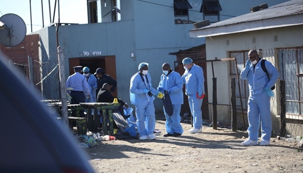 Forensic personnel investigate after the deaths of patrons found inside the Enyobeni Tavern, in Scenery Park, outside East London in the Eastern Cape province, South Africa. REUTERS