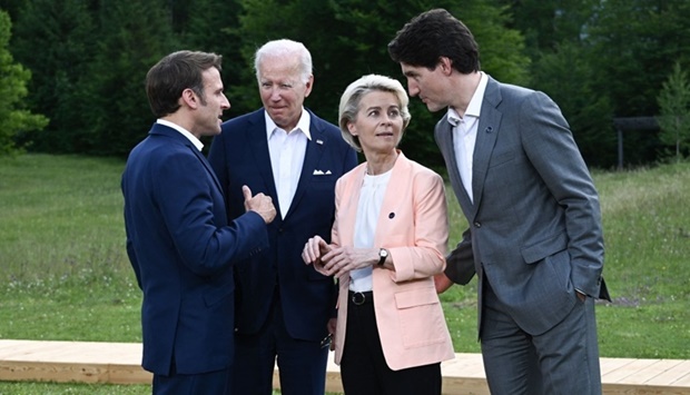 (L-R) France's President Emmanuel Macron, US President Joe Biden, European Commission President Ursula von der Leyen and Canada's Prime Minister Justin Trudeau chat as they leave after posing for a family photo during the G7 Summit held at Elmau Castle, southern Germany. AFP