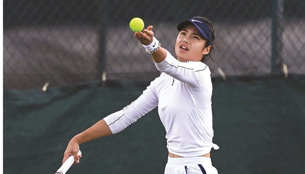 Britainu2019s Emma Raducanu returns the ball during a training session at The All England Tennis Club in Wimbledon, southwest London, yesterday. (AFP)