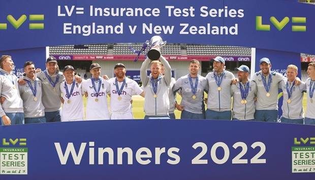 Englandu2019s captain Ben Stokes (centre) holds up the series trophy as England players celebrate after winning the third Test against New Zealand at the Headingley Cricket Ground in Leeds, northern England, yesterday. (AFP)