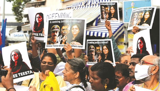 Demonstrators hold placards during a protest in Mumbai yesterday over the arrest of rights activist Teesta Setalvad.
