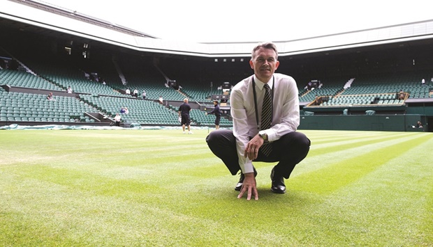 In this file photo taken on June 26, 2014, head groundsman Neil Stubley poses on the grass of centre court during the 2014 Wimbledon Championships at The All England Tennis Club in Wimbledon, southwest London. (AFP)