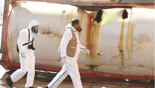 Jordanian forensic experts inspect the site of a toxic gas explosion in the Red Sea port of Aqaba, yesterday.