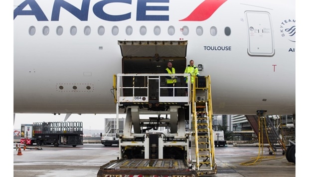 Ground crew prepare to receive cargo for loading into the hold of an Air France-KLM passenger aircraft at Paris Charles de Gaulle airport. As with many products shipped by air, effective standards, globally implemented, are needed to ensure safety.
