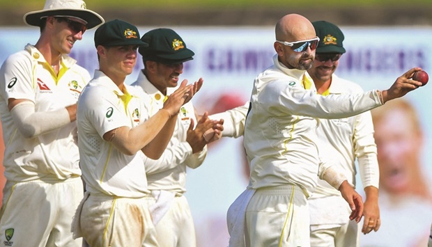 Australiau2019s Nathan Lyon (second right) celebrates after taking five wickets as his teammates watch during the first day of the first Test against Sri Lanka at the Galle International Cricket Stadium in Galle yesterday. (AFP)