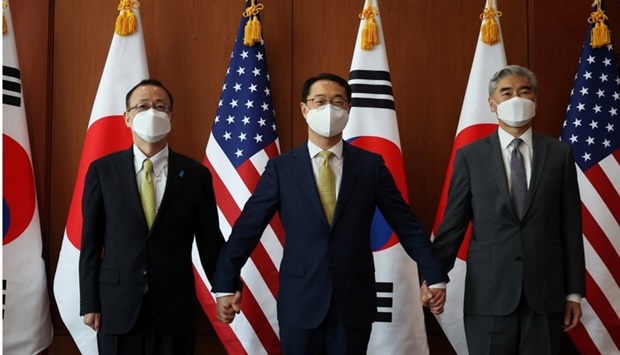 Kim Gunn, South Korea's new special representative for Korean Peninsula peace and security affairs, his US counterpart Sung Kim and Japanese counterpart Takehiro Funakoshi pose for photographs before their meeting at the Foreign Ministry in Seoul, South Korea. REUTERS