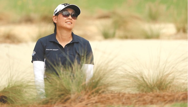 Mina Harigae reacts after playing a shot from the bunker near the first green during the second round of the 77th US Womenu2019s Open at Pine Needles Lodge and Golf Club in Southern Pines, North Carolina. (AFP)