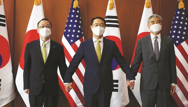 Kim Gunn, South Koreau2019s new special representative for Korean Peninsula peace and security affairs, his US counterpart Sung Kim and Japanese counterpart Takehiro Funakoshi pose for photographs before their meeting at the Foreign Ministry in Seoul, South Korea.