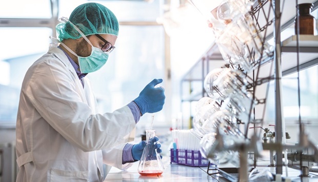 A chemist working with chemical substances during scientific experiment in laboratory.