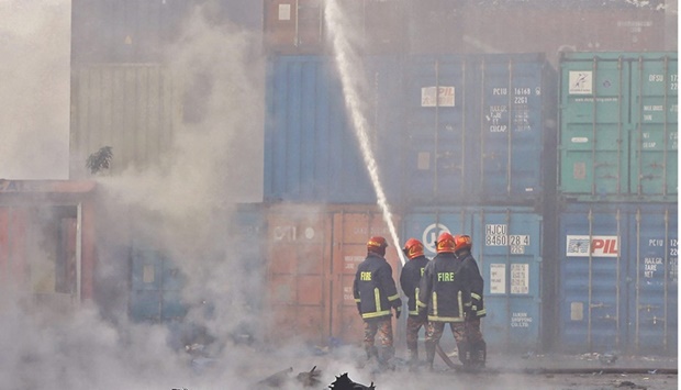 Firefighters try to extinguish a fire that broke out at a container storage facility in Sitakunda, about 40km from the key port of Chittagong in Bangladesh yesterday.
