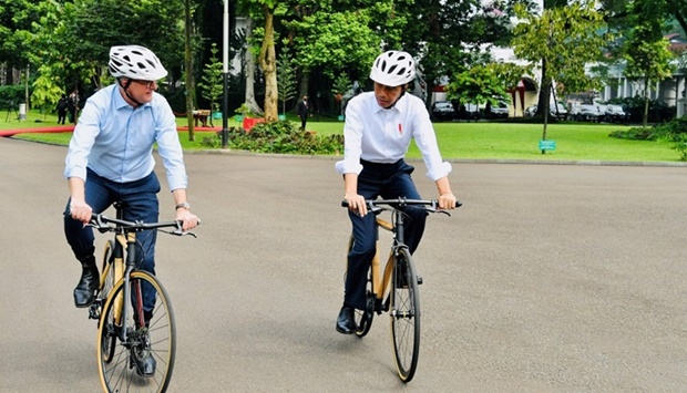 Indonesiau2019s President Joko Widodo (R) and Australiau2019s Prime Minister Anthony Albanese (L) riding bamboo bicycles at the Presidential Palace in Bogor, West Java. AFP/Presidential Palace/Laily Rachev