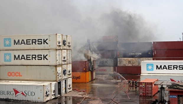 Firefighters try to extinguish a fire Sunday that broke out at a shipping container storage facility in Sitakunda, about 40 km from the key port of Chittagong.