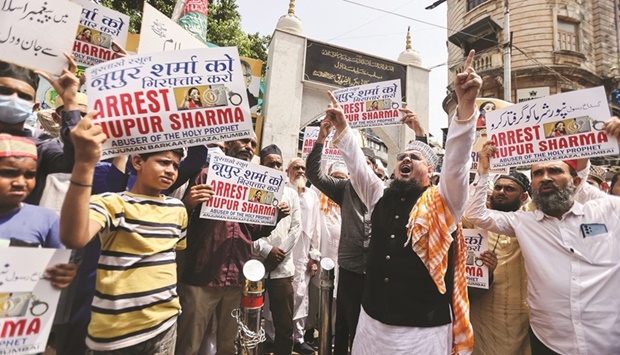 People holding placards shout slogans demanding the arrest of Bharatiya Janata Party (BJP) member Nupur Sharma for her controversial comments, on a street in Mumbai, yesterday.