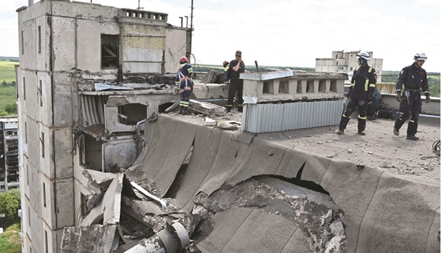 Rescuers dismantle collapsing structures of a heavily damaged 16-storey residential building in the Saltivka district, northern Kharkiv, yesterday. (AFP)