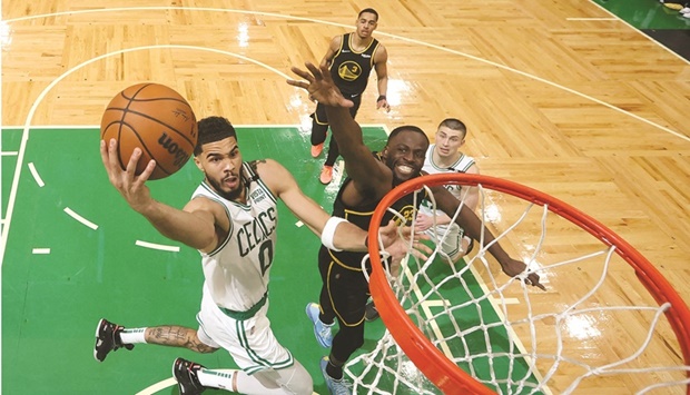 Boston Celtics forward Jayson Tatum (0) attempts a basket in front of Golden State Warriors forward Draymond Green (23) in the second half during Game Three of the 2022 NBA Finals. (USA TODAY Sports)