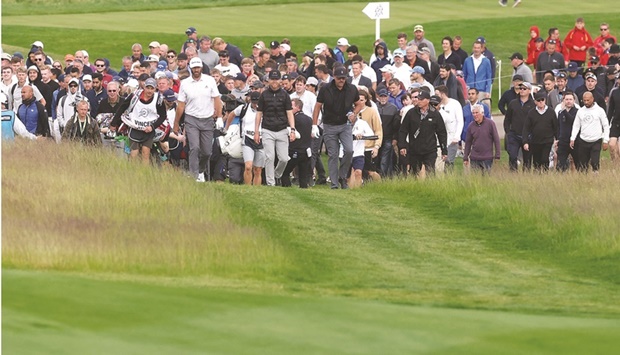 Dustin Johnson (left) of the US, Zimbabweu2019s Scott Vincent (centre) and Phil Mickelson of the US during the first round of the LIV Golf Invitational in St Albans, Britain. (Reuters)