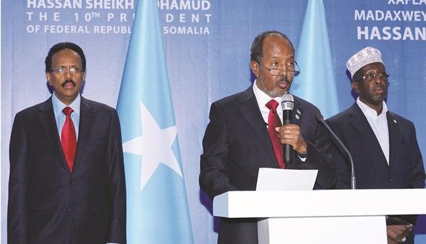 Somaliau2019s new President Hassan Sheikh Mahmoud speaks with former president Mohamed Abdullahi Mohamed (left) and former president Sharif Sheikh Ahmed during his inauguration ceremony as the 10th president with the presence of three heads of state, Kenya, Ethiopia, and Djibouti, in Mogadishu.