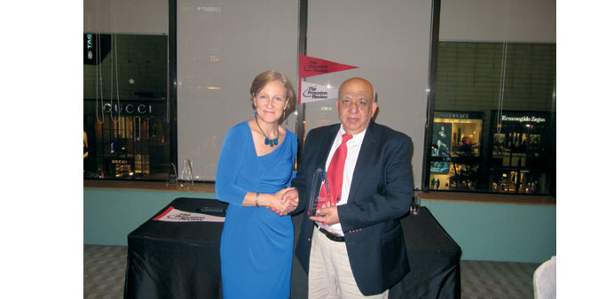  ScorePlus Middle East chairman shakes hands with Ellinger after receiving the award.