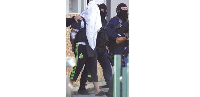 A man believed to be Yassin Salhi is escorted by police officers during investigations in Saint-Priest, near Lyon.