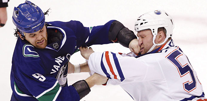 Vancouver Canucksu2019 Zack Kassian lands a punch on Edmonton Oilersu2019 Ben Eager (R) during the third period of their NHL hockey game in Vancouver, British