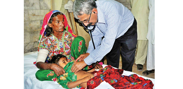 A woman and her child affected from a famine receive medical treatment at a hospital in Mitthi, Sindh province.