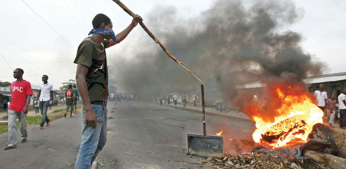 Protesters stand in front of a burning barricade during a protest in Bujumbura against Burundi President Pierre Nkurunzizau2019s bid for a third term.