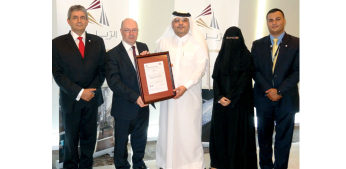 A Qatar Rail official receiving the ISO certificate.
