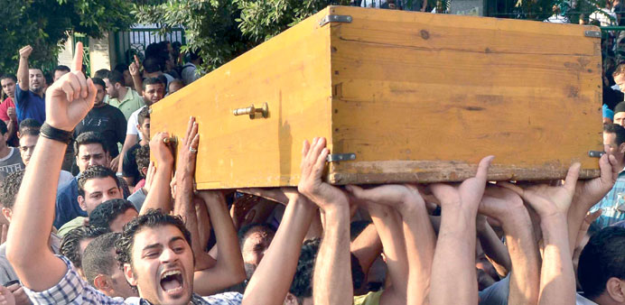 Mourners shout slogans as they carry the coffin of a victim of Fridayu2019s clashes during a funeral ceremony in the Cairo neighbourhood of Manial yesterd