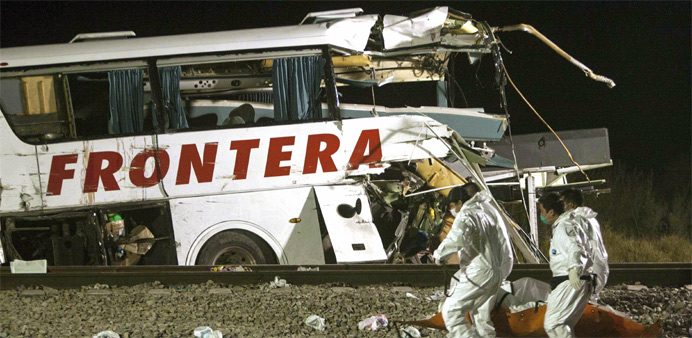 The wreckage of a passenger bus is seen at the site of an accident in Anahuac
